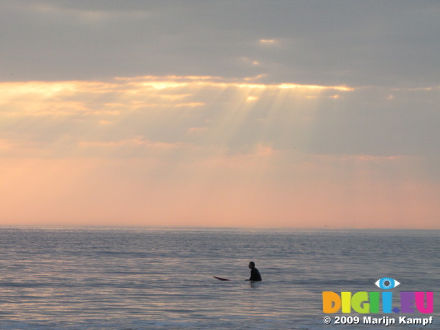 SX03507 Surfer waiting for wave at Ogmore by Sea